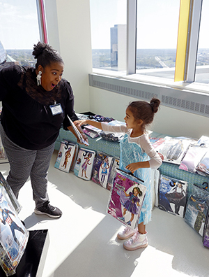 CHoR patient Lexi picks out a princess costume at the hospital Halloween party