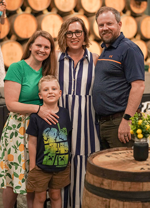 CHoR patient James and his parents with Dr. Jordyn Griffin at a LemonAid event