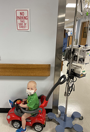 CHoR patient James driving his toy car while in the hospital
