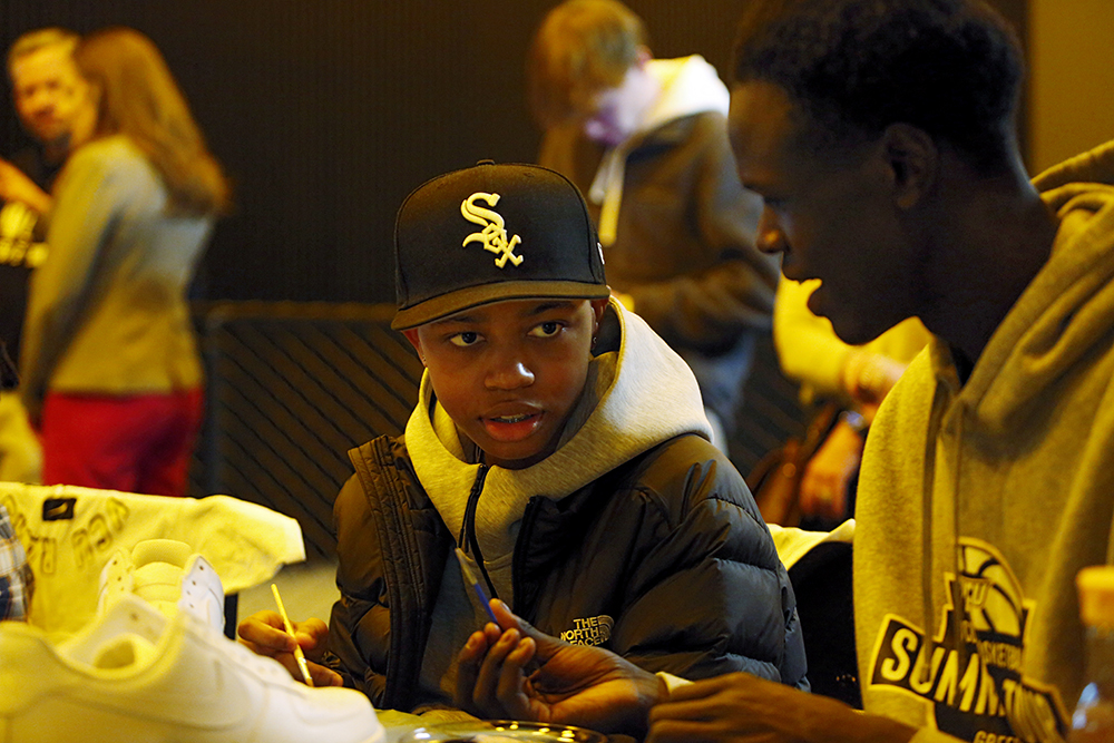 CHoR patient Omari Briggs paints sneakers with VCU player Kuany Kuany