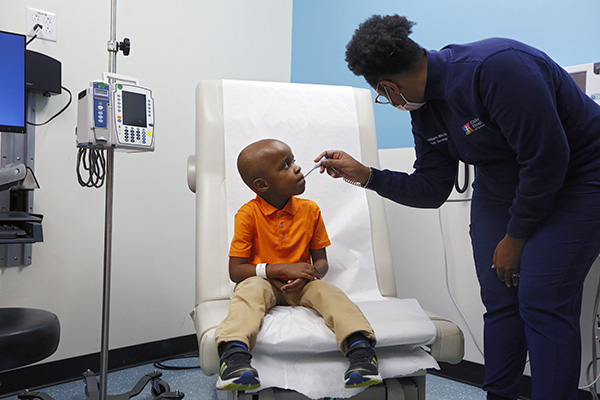 CHoR patient Wesley getting his temperature checked in clinic