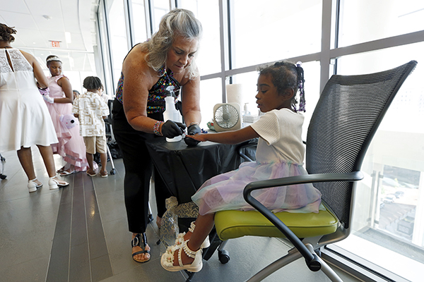A CHoR nurse paints a patient's nails at prom