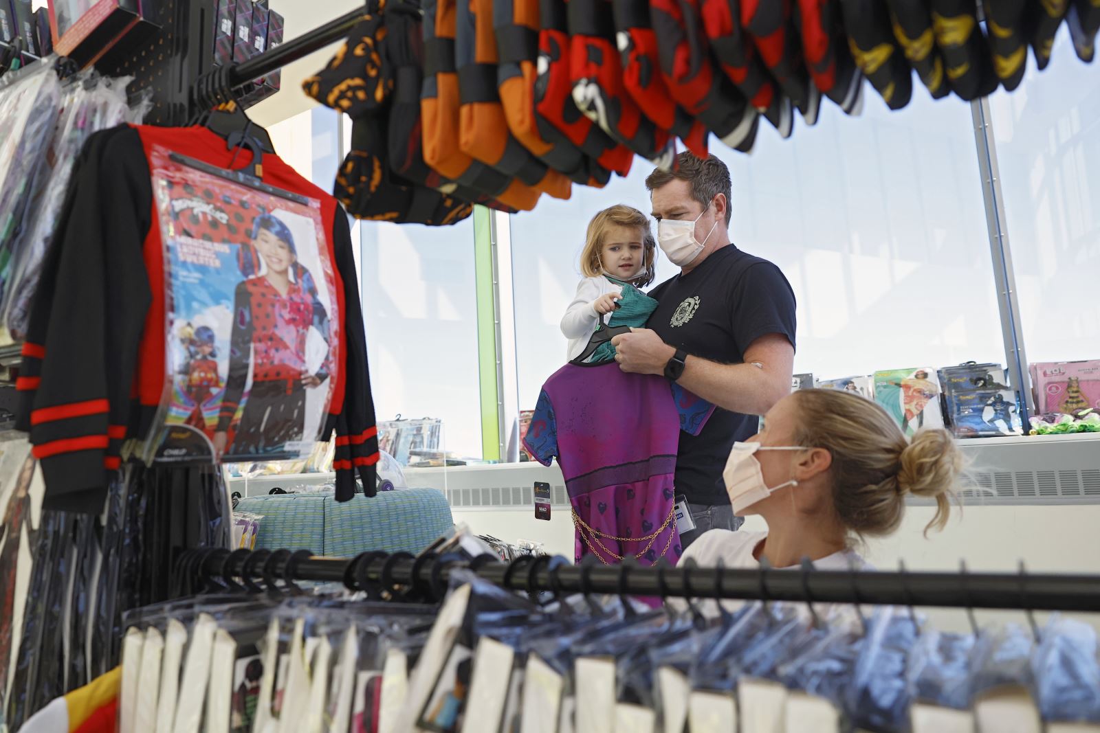 tiny patient looks at costumes at Spirit Halloween event