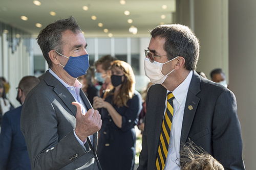 Virginia Gov. Ralph Northam, left, speaks with Art Kellermann, CEO of VCU Health System
