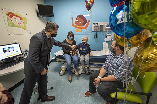 Becerra, left, greets Johnny Richter at Children's Hospital of Richmond at VCU. 