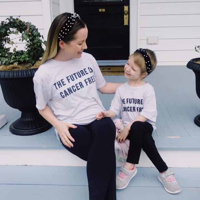 Andi wearing a shirt that says the future is cancer free