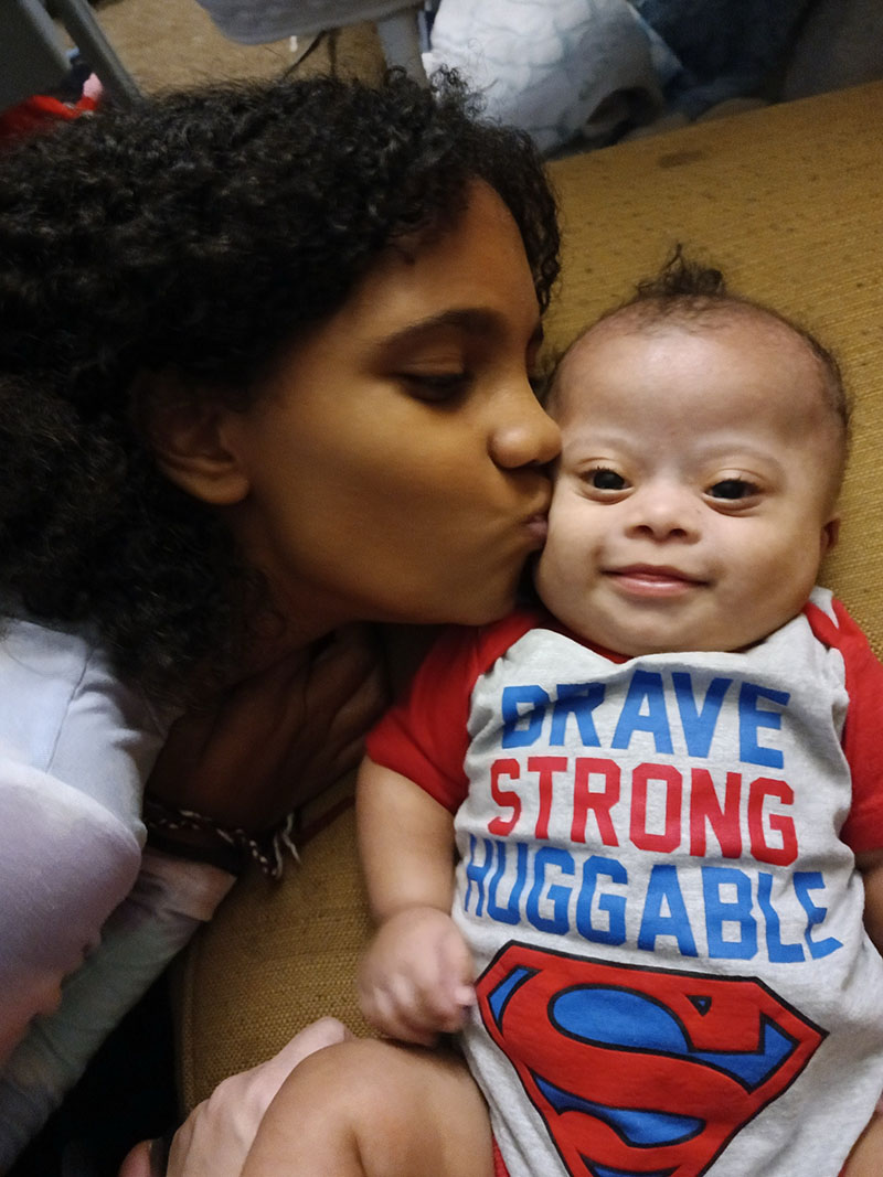 CHoR patient Asher as a baby getting a kiss from big sister