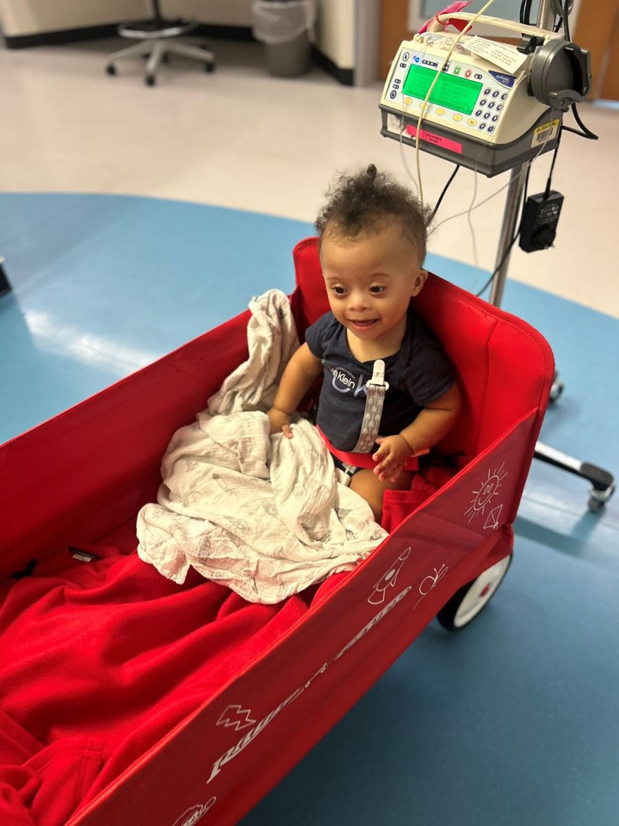 CHoR patient Asher riding in a wagon at the hospital