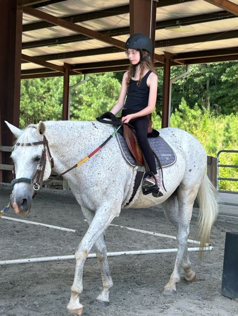 CHoR patient Astrid Luck riding a white horse