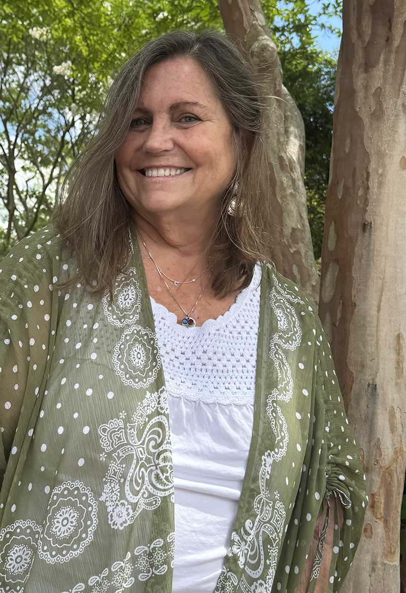 CHoR's Bobbie Terrell smiling outside under a tree