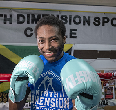 CHoR patient Walter Davis smiling at the camera wearing his boxing gloves