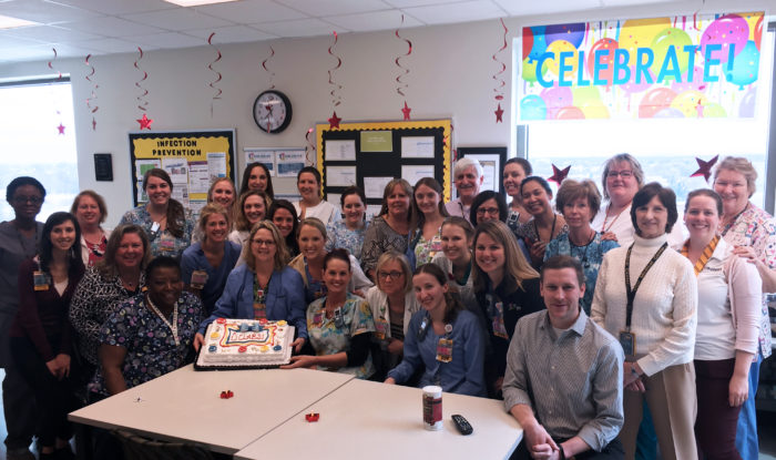 NICU team members celebrating with cake
