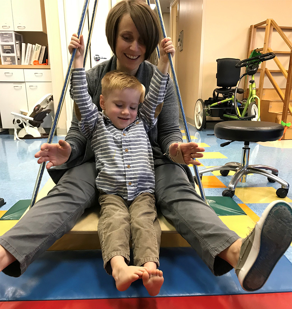 Caiden and his physical therapist, Lisa