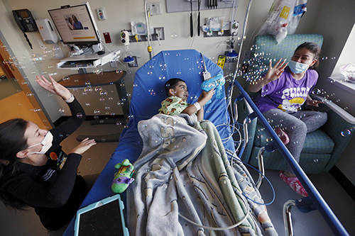 Child blowing bubbles in the Children's Tower emergency room