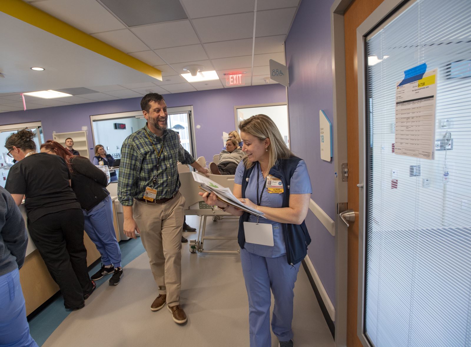 CHoR ED doctor and nurse wheeling patient down hall