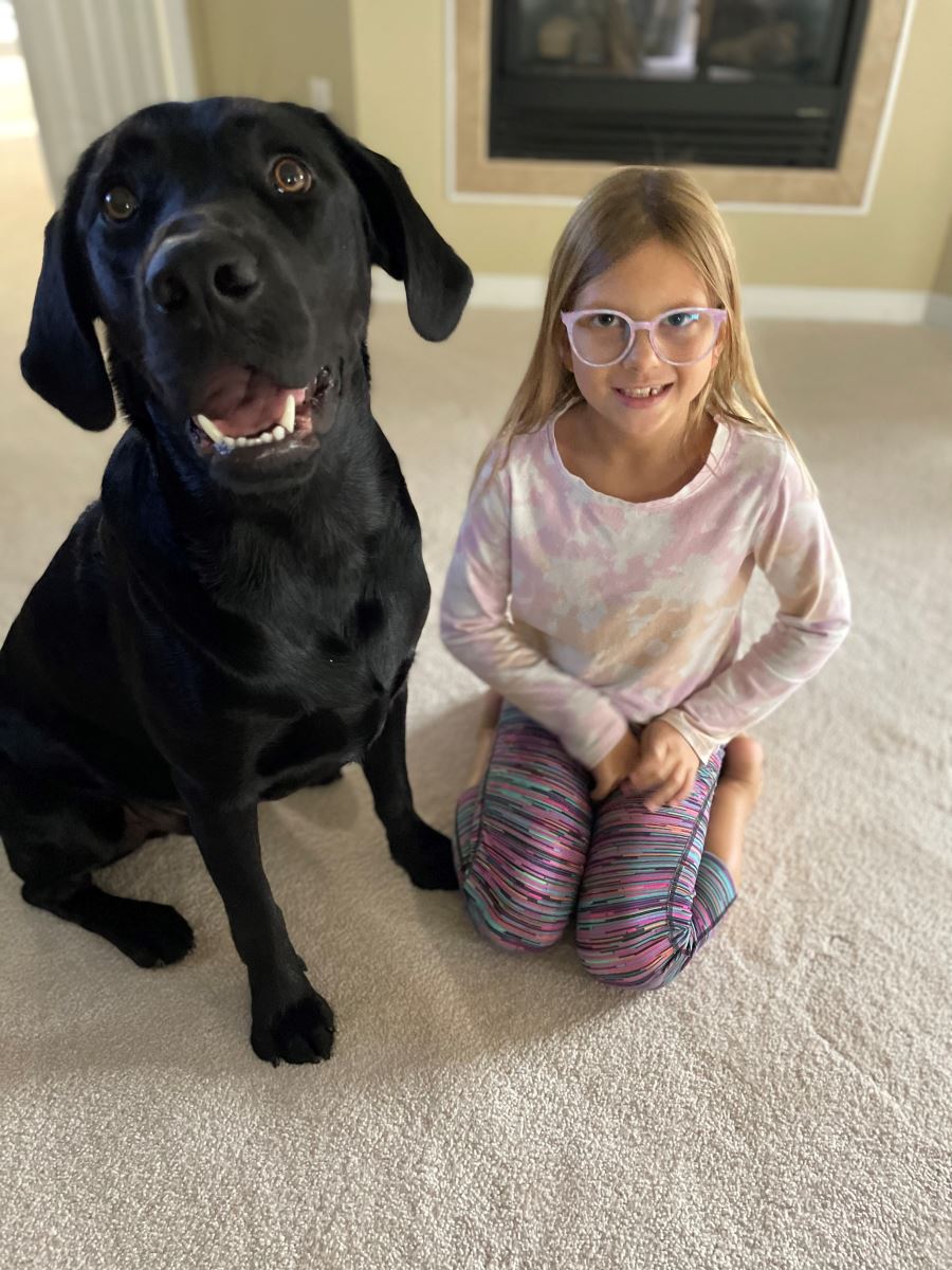 CHoR patient Elizabeth at home with her black lab Franklin