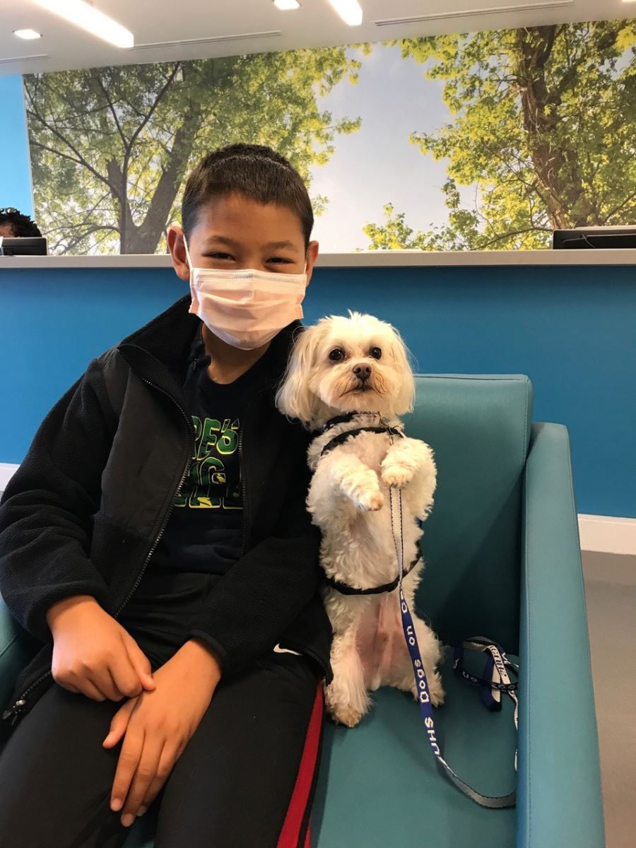 Eric Waligoria with support dog from Dogs on Call Therapy program
