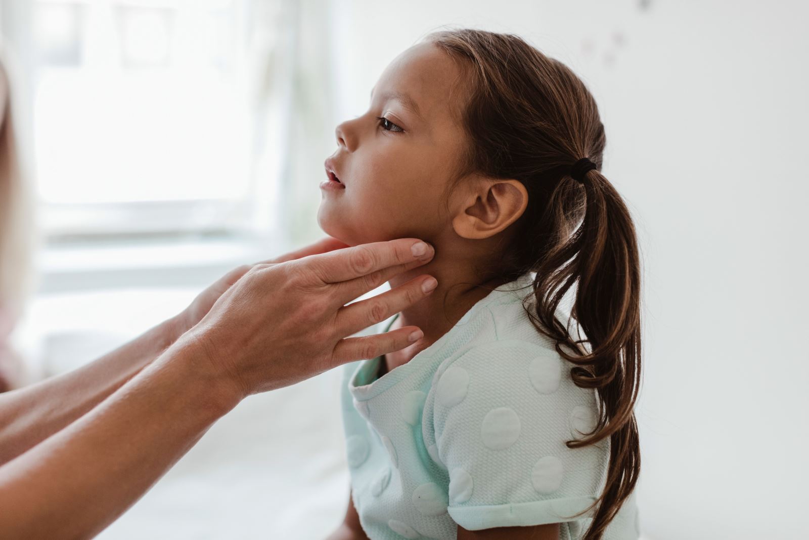 Child having neck inspected for pediatric research