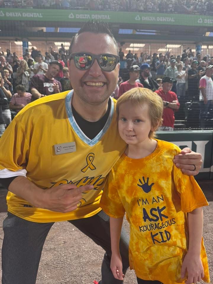 Emma poses with Flying Squirrels GM Anthony Oppermann