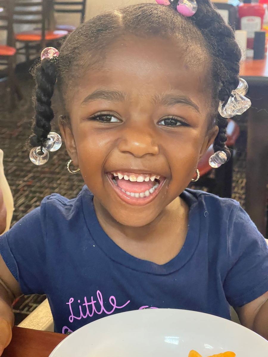 CHoR Calendar Kid Kemiyah laughing at a restaurant