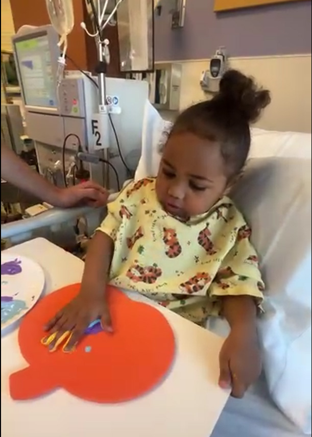 CHoR patient Lux painting a pumpkin during art therapy in the hospital