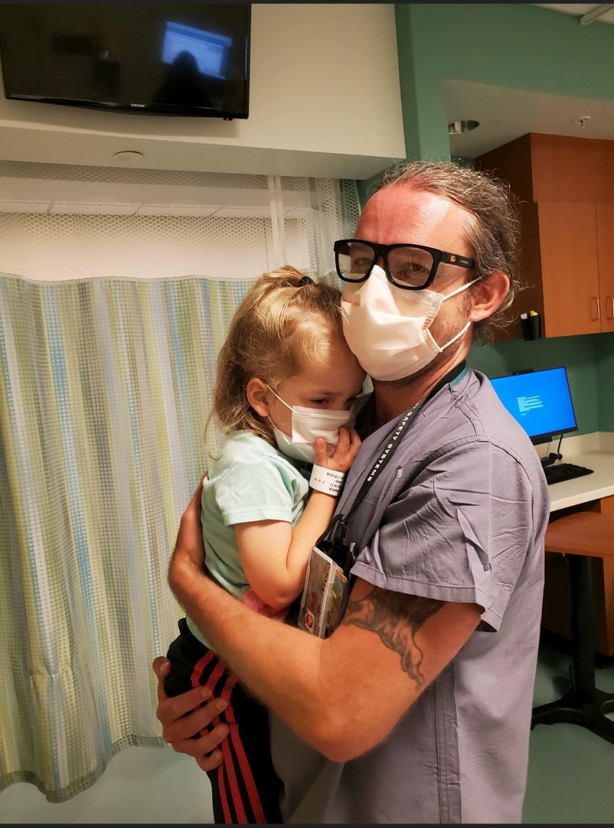 CHoR MRI tech Dave Bessom holds patient Maria