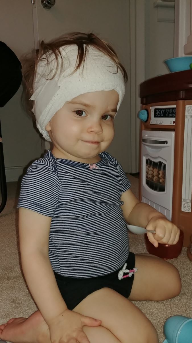 CHoR patient Maria Noles with her head wrapped for safety