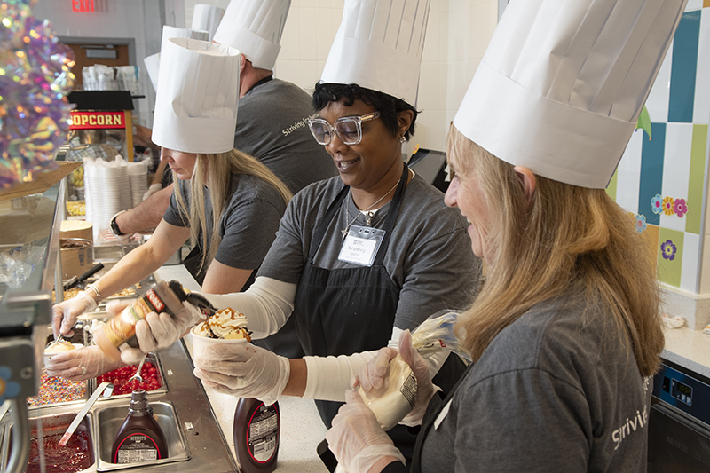 Markel team members serving ice cream sundaes at CHoR