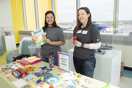 Markel team members smile with carnival prizes at CHoR