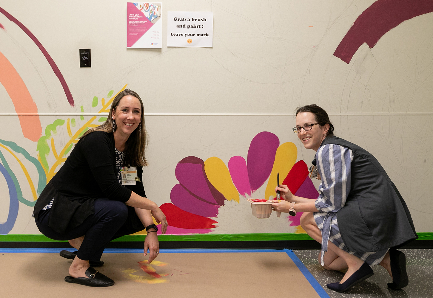 Alexis Shockley and team member in front of CHoR mural