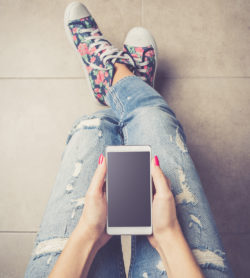 Overhead Shot Of Woman Holding Smart Phone