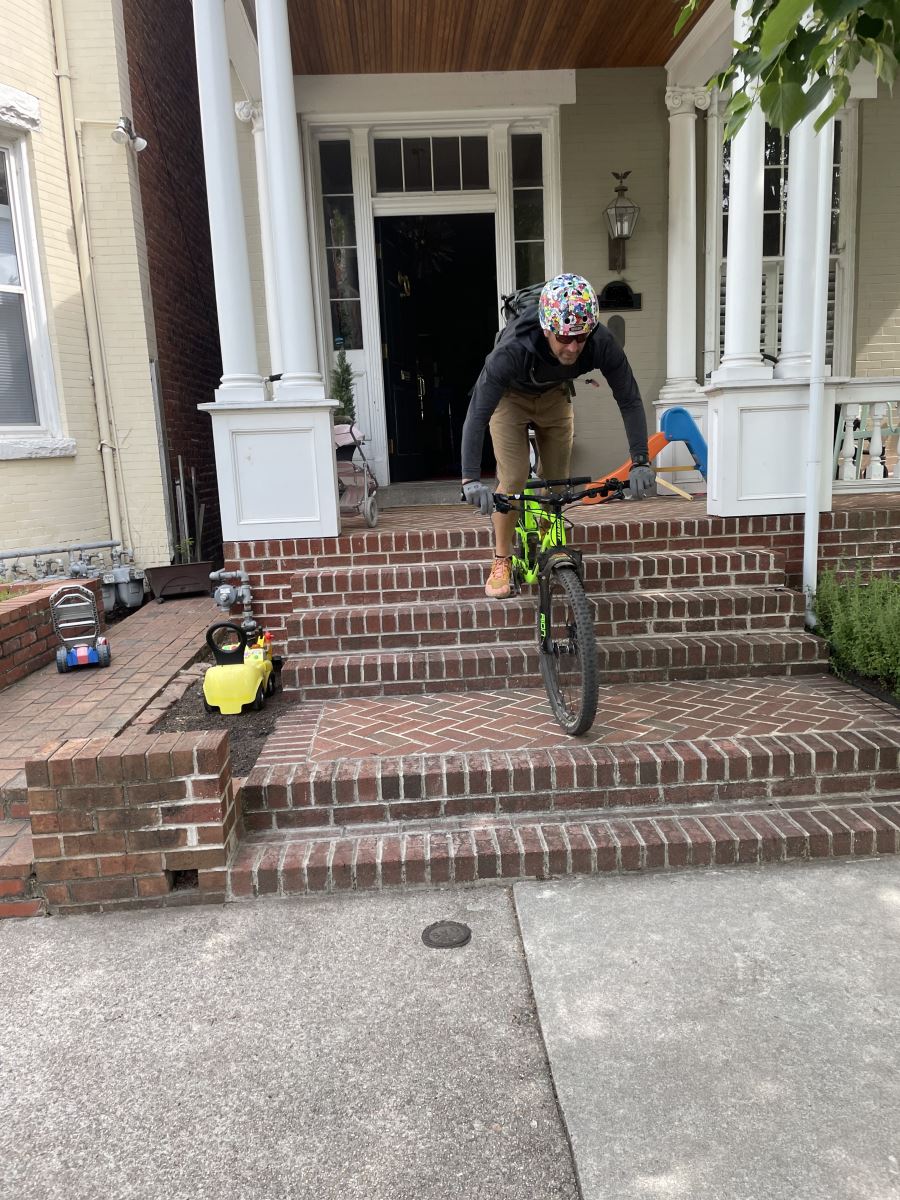 CHoR doctor Mike Ryan riding his bike on the stairs