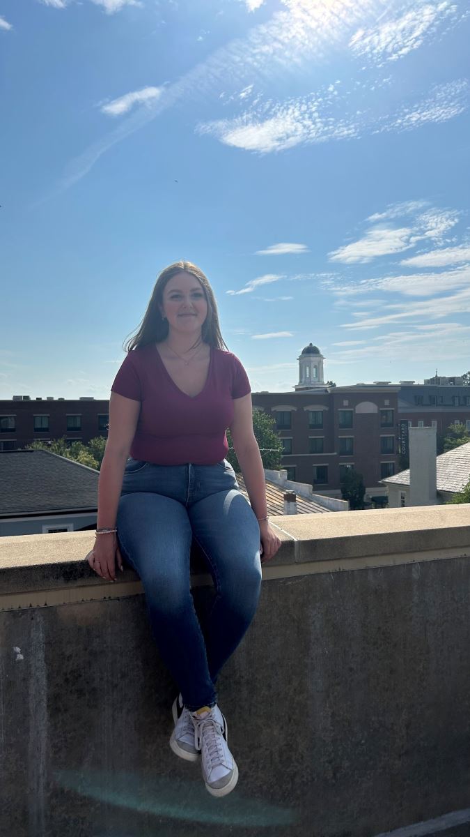CHoR patient Sarah sitting on a wall outside