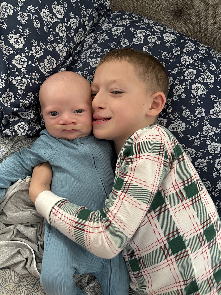 Hudson Walton hugs his baby brother Hayes
