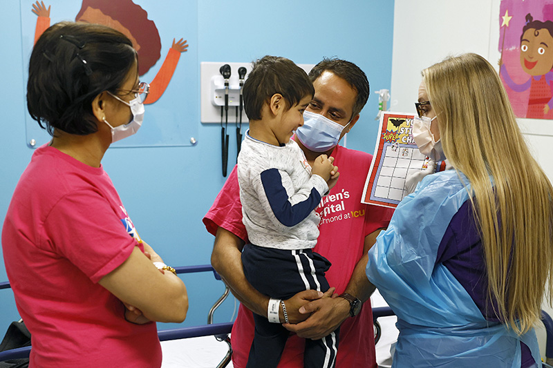 CHoR nurse Megan Beatley showing Yug his sticker chart