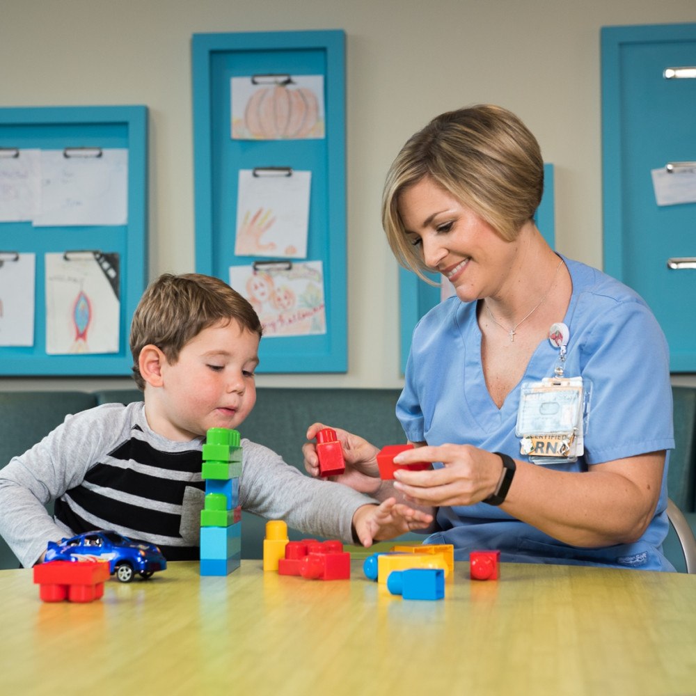 Jaiden Scelzo developed a special bond with Dianna Wills, RN, during his weekly cancer treatment at CHoR. “She treats Jaiden like one of her own,” said Jaiden’s mom, Jackie. (Photo by Doug Buerlein)